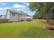Large backyard featuring a well-maintained lawn, a fire pit, and a shaded gazebo, great for entertaining at 285 Finsbury Park Ct, Suwanee, GA 30024