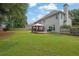 Expansive backyard with lush lawn, a fire pit, and a gazebo on the deck, creating an ideal outdoor retreat at 285 Finsbury Park Ct, Suwanee, GA 30024