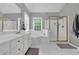 Bathroom boasting dual sinks, a soaking tub, and a glass-enclosed shower, bathed in natural light at 285 Finsbury Park Ct, Suwanee, GA 30024