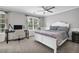 Bright bedroom with a ceiling fan, two windows, a desk, and a white bed frame at 285 Finsbury Park Ct, Suwanee, GA 30024