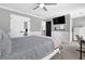 Spacious bedroom featuring a large window, a ceiling fan, and neutral color tones at 285 Finsbury Park Ct, Suwanee, GA 30024