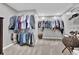Walk-in closet with ample hanging space and shelving, perfect for organized storage in the home at 285 Finsbury Park Ct, Suwanee, GA 30024