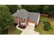 Classic brick home boasts a well-manicured lawn and attached two-car garage, providing comfort and style at 285 Finsbury Park Ct, Suwanee, GA 30024