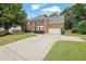 Attractive brick home with a spacious driveway and landscaped lawn, perfect for Gathering living and outdoor enjoyment at 285 Finsbury Park Ct, Suwanee, GA 30024