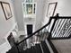 Elegant two-story foyer with hardwood floors, chandelier, and staircase with decorative iron railing at 285 Finsbury Park Ct, Suwanee, GA 30024