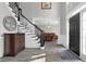 Grand foyer with a staircase, dark wood floors, elegant chandelier, and open view to the dining room at 285 Finsbury Park Ct, Suwanee, GA 30024