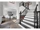 Spacious foyer with staircase, gray walls, and a glimpse of the office, showcasing a welcoming layout at 285 Finsbury Park Ct, Suwanee, GA 30024