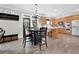 Eat-in kitchen features stainless steel appliances, wood cabinets, and views of the covered patio at 285 Finsbury Park Ct, Suwanee, GA 30024