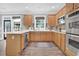 Well-equipped kitchen with wood cabinets, stainless appliances, and a spacious countertop at 285 Finsbury Park Ct, Suwanee, GA 30024