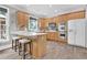 Bright kitchen features wood cabinets, stainless appliances, and a breakfast bar with seating at 285 Finsbury Park Ct, Suwanee, GA 30024