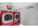 Laundry room with modern stacked washer and dryer at 285 Finsbury Park Ct, Suwanee, GA 30024