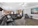 Open concept living room with a large sectional, leading to the kitchen and dining area at 285 Finsbury Park Ct, Suwanee, GA 30024