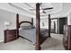 Elegant main bedroom with four-poster bed, tray ceiling, and ensuite bathroom at 285 Finsbury Park Ct, Suwanee, GA 30024