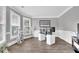 Bright home office with large windows, stylish gray walls, modern desk setup, and wood-look flooring at 285 Finsbury Park Ct, Suwanee, GA 30024