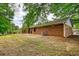 A spacious backyard featuring a well-maintained lawn and a classic brick home at 2931 Randolph Ct, Conyers, GA 30012
