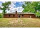 A spacious backyard featuring a well-maintained lawn and a classic brick home at 2931 Randolph Ct, Conyers, GA 30012