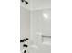 Modern bathroom with a sleek, white shower featuring black fixtures and grab bar at 2931 Randolph Ct, Conyers, GA 30012