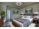 Comfortable bedroom with ensuite bath, featuring plush bedding, stylish decor, and doors to living spaces at 2931 Randolph Ct, Conyers, GA 30012