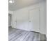 Bedroom featuring sleek flooring and modern fixtures, with doors leading to closet and other rooms at 2931 Randolph Ct, Conyers, GA 30012