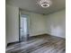 Spacious bedroom showcasing sleek flooring and access to additional rooms, with abundant light at 2931 Randolph Ct, Conyers, GA 30012