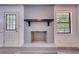 Close-up of a painted brick fireplace, wooden mantel, and adjacent window and door at 2931 Randolph Ct, Conyers, GA 30012