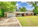 Charming brick home with manicured lawn, attached garage, and inviting front porch at 2931 Randolph Ct, Conyers, GA 30012