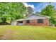 Charming brick home with manicured lawn, attached garage, and inviting front porch at 2931 Randolph Ct, Conyers, GA 30012