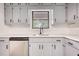 Close-up of the kitchen area with gray cabinets and stainless steel appliances at 2931 Randolph Ct, Conyers, GA 30012