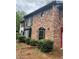 Brick townhome exterior featuring classic architectural details and well-kept landscaping at 658 Garden Walk Dr, Stone Mountain, GA 30083