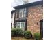 The brick townhome showcases traditional design elements and inviting front yard landscaping at 658 Garden Walk Dr, Stone Mountain, GA 30083