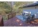 Cozy outdoor back deck featuring stylish seating with a sleek outdoor rug and backyard views at 696 Kenilworth Cir, Stone Mountain, GA 30083