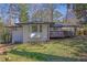 Rear exterior view of home with back deck, bay window, and patio, nestled in a well-manicured lawn at 696 Kenilworth Cir, Stone Mountain, GA 30083