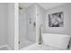 Stylish bathroom featuring a sleek tub, glass-enclosed shower, and modern fixtures for a spa-like experience at 696 Kenilworth Cir, Stone Mountain, GA 30083