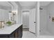 Updated bathroom with a glass shower, double vanity, and stylish tile work, offering a contemporary design at 696 Kenilworth Cir, Stone Mountain, GA 30083
