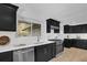 Modern kitchen with stainless appliances, gas range, black cabinets, and white countertops at 696 Kenilworth Cir, Stone Mountain, GA 30083