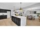 Bright open kitchen with a large island, black cabinets, stainless appliances, and ample space at 696 Kenilworth Cir, Stone Mountain, GA 30083