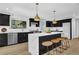 Modern kitchen featuring black cabinets, stainless appliances, marble island, and pendant lighting at 696 Kenilworth Cir, Stone Mountain, GA 30083