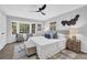 Serene main bedroom featuring large windows, stylish decor, and a cozy seating area at 696 Kenilworth Cir, Stone Mountain, GA 30083