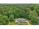 An aerial view showcases this cozy home nestled among a lush, dense forest at 105 Laney Ct, Mcdonough, GA 30252