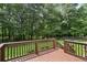 Wooden back deck overlooking a green, wooded backyard at 105 Laney Ct, Mcdonough, GA 30252