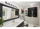 Bathroom featuring a bathtub, a large mirror, and a vanity with dark cabinets at 105 Laney Ct, Mcdonough, GA 30252
