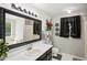 Chic bathroom with a large framed mirror, a garden tub, and black and white accents at 105 Laney Ct, Mcdonough, GA 30252