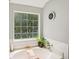 Bright bathroom featuring a large window, tub, and gray walls at 105 Laney Ct, Mcdonough, GA 30252
