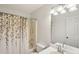 Bathroom featuring a shower-tub combo, floral shower curtain, and a large mirror at 105 Laney Ct, Mcdonough, GA 30252