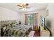 Bedroom featuring hardwood floors, a ceiling fan, and a large window at 105 Laney Ct, Mcdonough, GA 30252