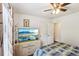 Inviting bedroom with hardwood floors, large screen television, ceiling fan, and light colored walls at 105 Laney Ct, Mcdonough, GA 30252
