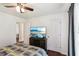 Bedroom featuring hardwood floors, a ceiling fan, and a large television at 105 Laney Ct, Mcdonough, GA 30252