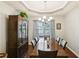 Elegant dining room with tray ceiling, classic chandelier, and large table, ideal for Gathering gatherings at 105 Laney Ct, Mcdonough, GA 30252