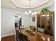 Formal dining room featuring a stylish chandelier, wood floors, and access to the kitchen at 105 Laney Ct, Mcdonough, GA 30252