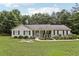 Charming single-story home with inviting front porch and beautifully landscaped front yard surrounded by mature trees at 105 Laney Ct, Mcdonough, GA 30252